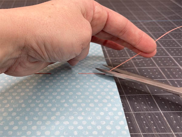 use a scissor to trim away the excess and make sure it's short enough so it doesn't stick out of the book